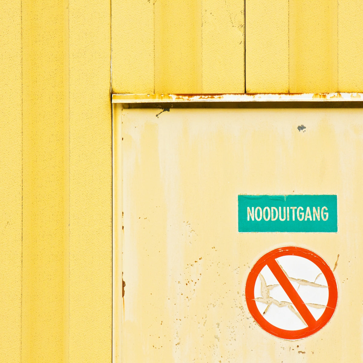 A yellow building with a no left turn sign on it