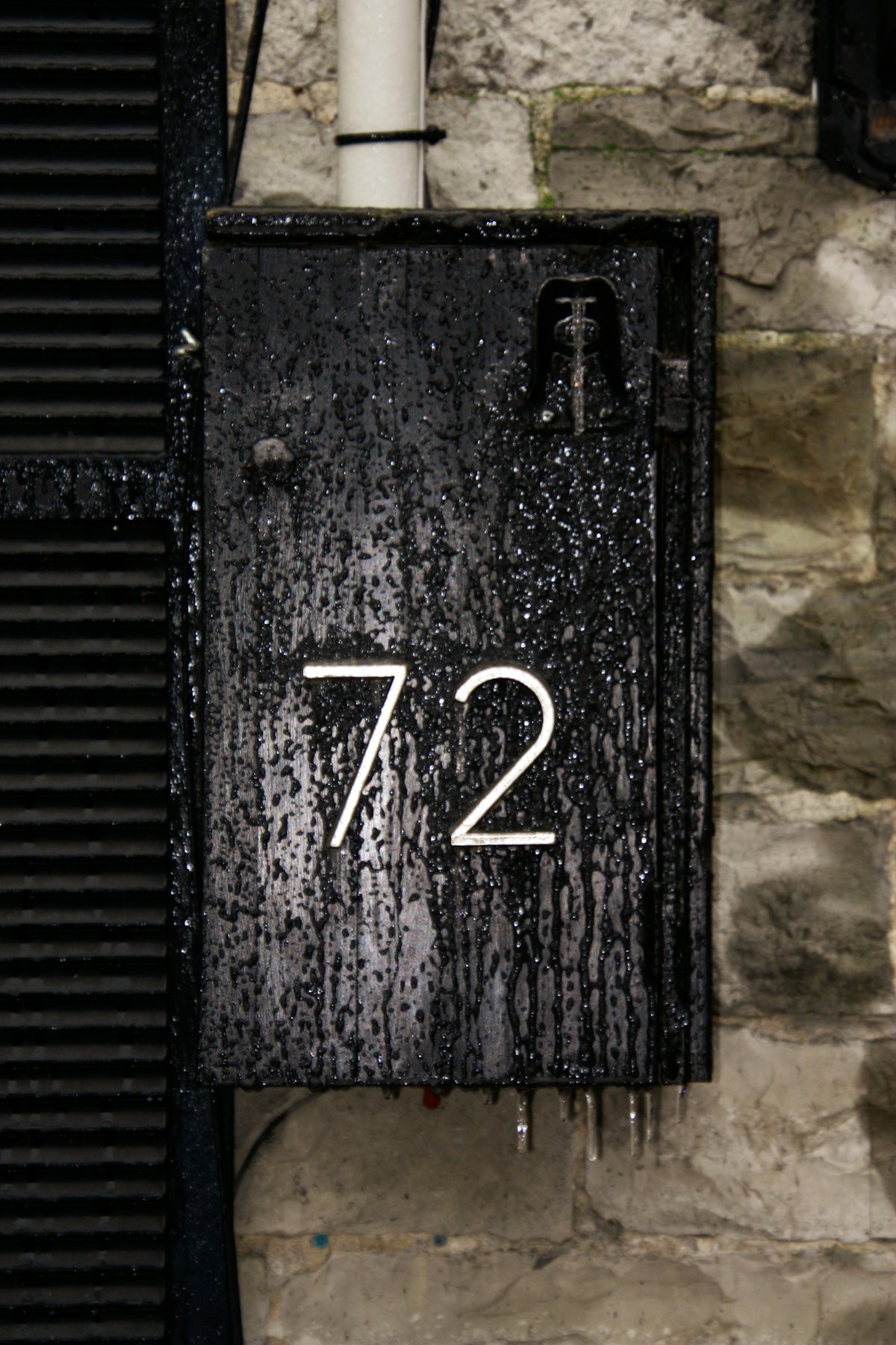 A weathered metal box displays the number 72.