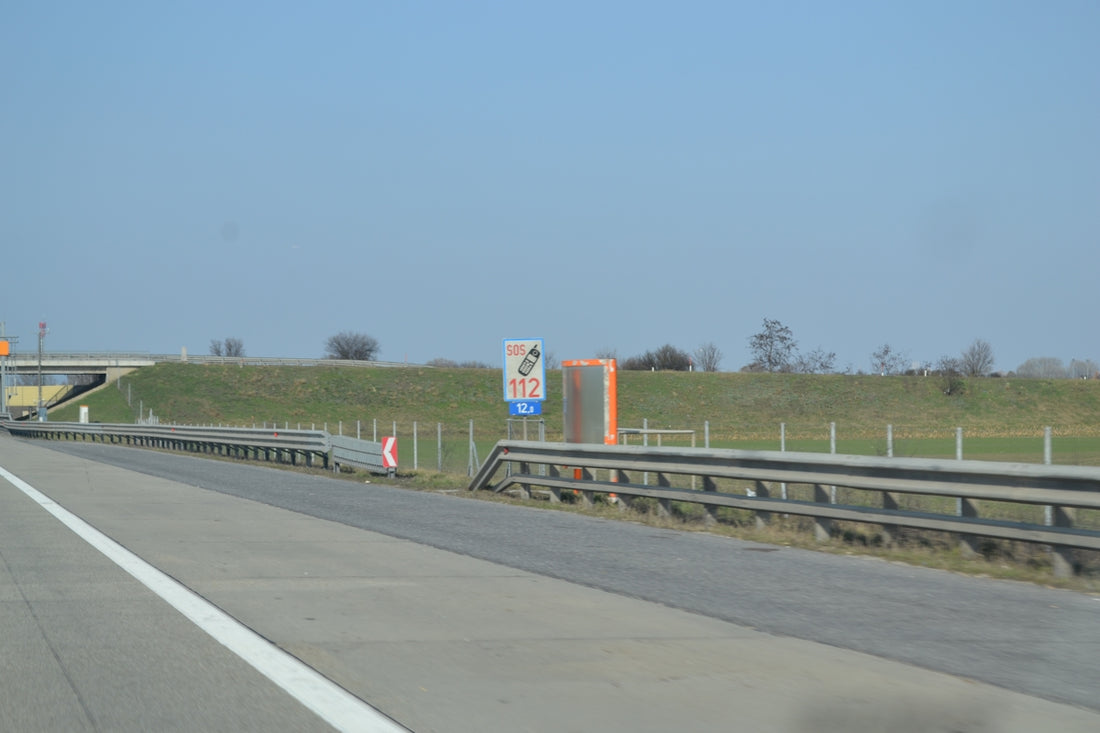 Highway with grassy embankment and signage