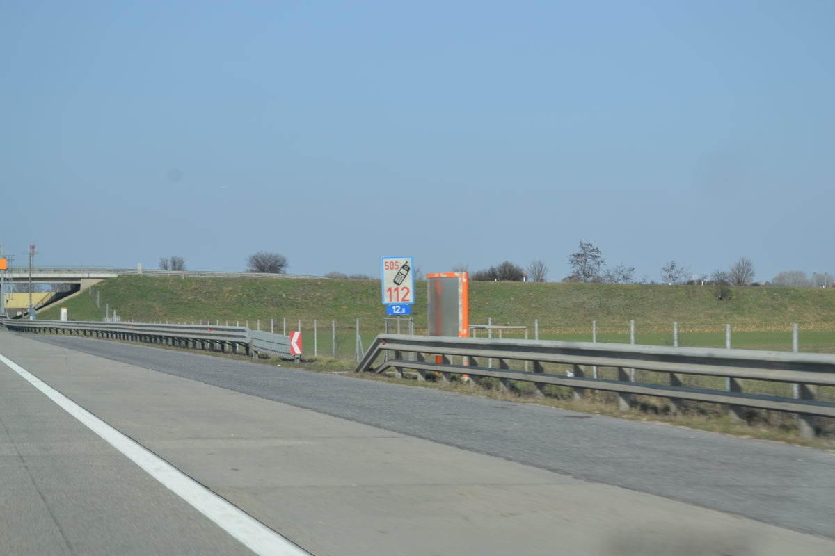 Highway with grassy embankment and signage