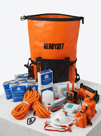 Orange 'READYSET' bag with various safety equipment on a white background