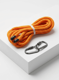 Orange rope with black carabiners on a white surface