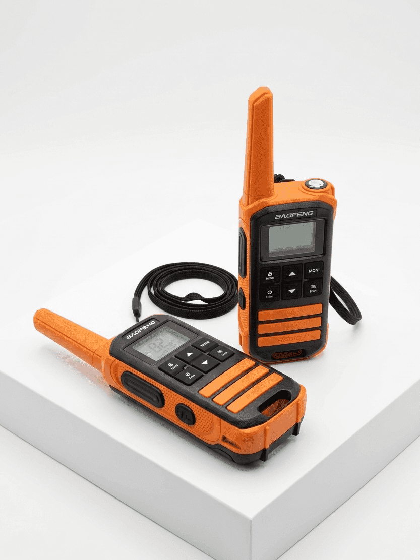 Two orange walkie-talkies on a white surface