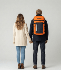 Two people holding hands, one with an orange backpack labeled 'ReadySet' on a plain background